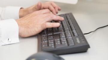 man using computer keyboard and mouse