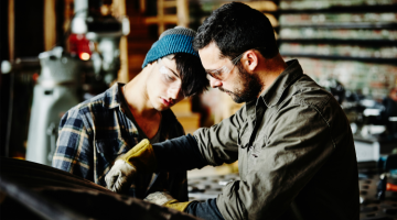 Metal worker and apprentice