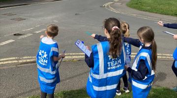 children pointing at the road